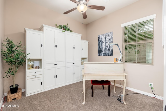 living area featuring carpet flooring, ceiling fan, and baseboards