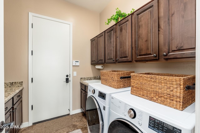 laundry room featuring separate washer and dryer, a sink, cabinet space, and baseboards