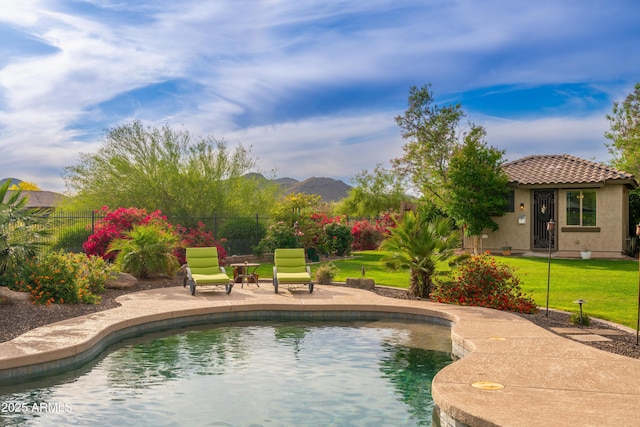 view of pool featuring fence, a fenced in pool, a lawn, and a patio