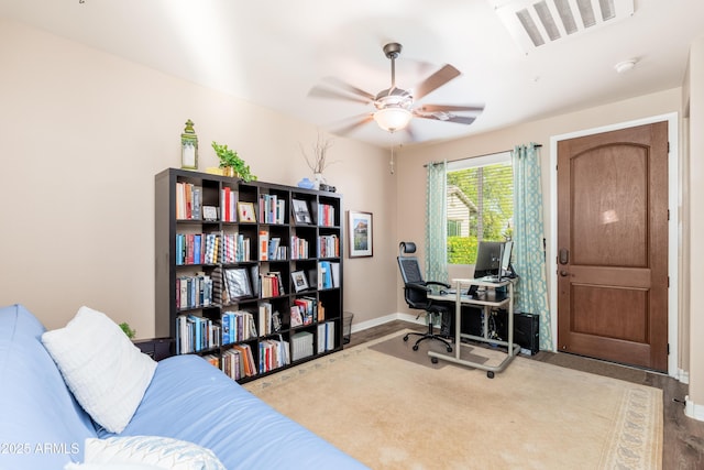 office featuring a ceiling fan, baseboards, and visible vents