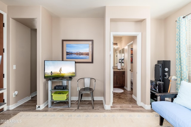 sitting room featuring baseboards and wood finished floors