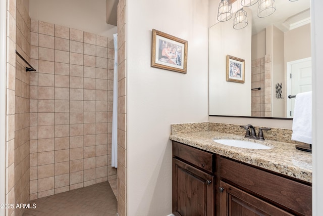 bathroom featuring vanity and tiled shower