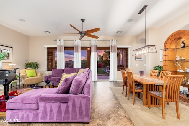 tiled living room with visible vents and a ceiling fan