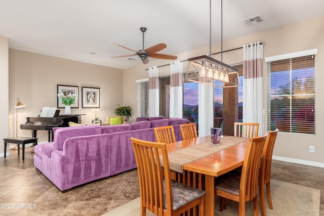 dining space with a ceiling fan, baseboards, and visible vents