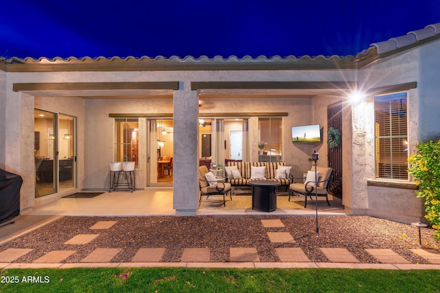 view of patio with an outdoor living space with a fire pit