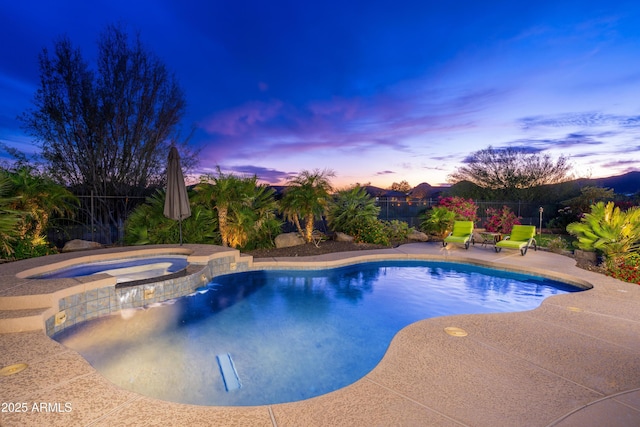 view of pool with a patio, fence, and a pool with connected hot tub