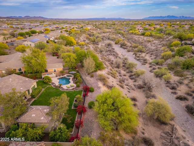 drone / aerial view featuring a residential view and a mountain view