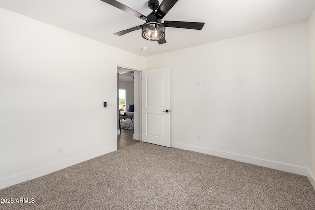 unfurnished room featuring baseboards, a ceiling fan, and light carpet