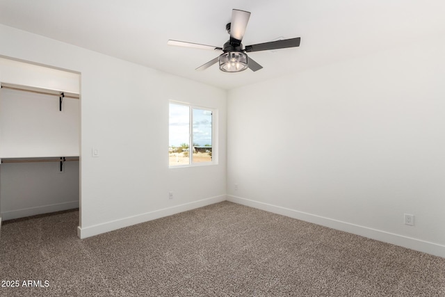 unfurnished bedroom with a closet, carpet, baseboards, and ceiling fan