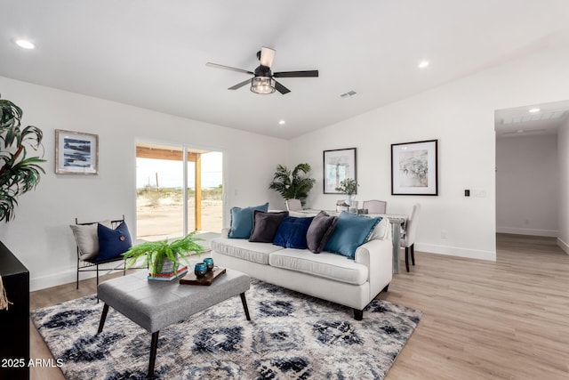 living room featuring visible vents, light wood finished floors, recessed lighting, a ceiling fan, and vaulted ceiling