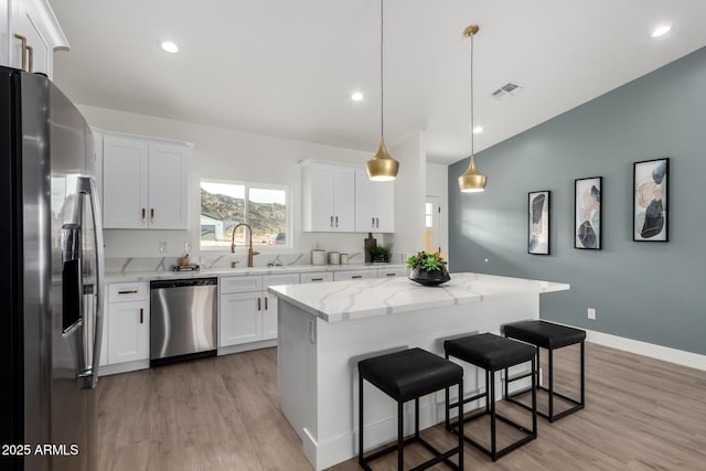 kitchen featuring a sink, visible vents, light wood-style floors, and appliances with stainless steel finishes