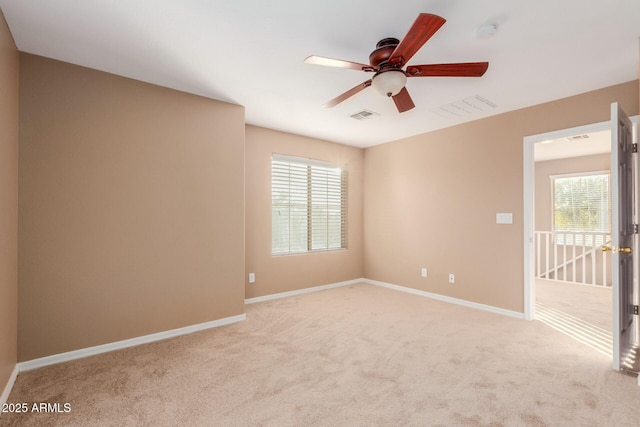 empty room with ceiling fan and light colored carpet