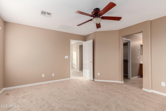 unfurnished bedroom featuring light carpet and ceiling fan