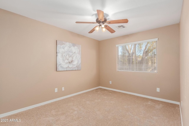 empty room featuring ceiling fan and light colored carpet