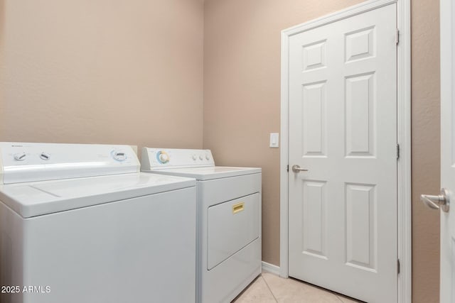 washroom with washer and dryer and light tile patterned floors