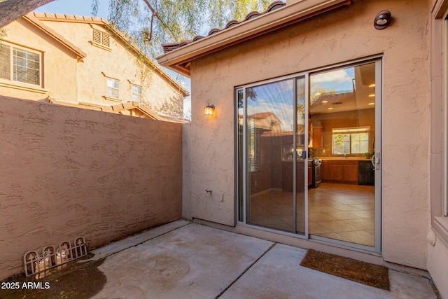 doorway to property featuring a patio area