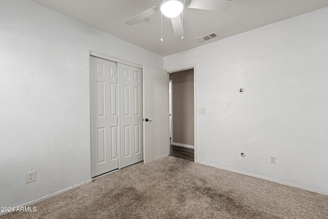 unfurnished bedroom featuring carpet flooring, ceiling fan, and a closet