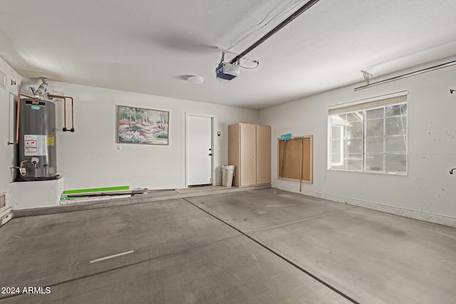 garage featuring a garage door opener and water heater