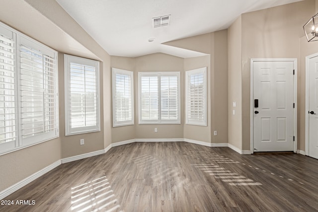 foyer entrance with dark wood-type flooring and a chandelier