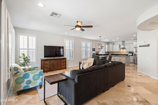 living room featuring recessed lighting, visible vents, plenty of natural light, and baseboards