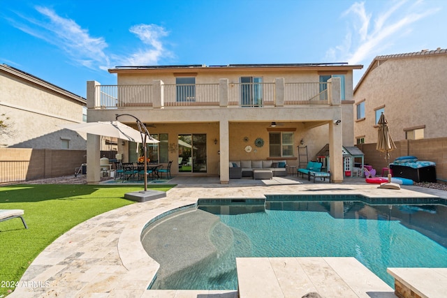 rear view of property featuring a patio, a fenced backyard, a balcony, an outdoor hangout area, and stucco siding