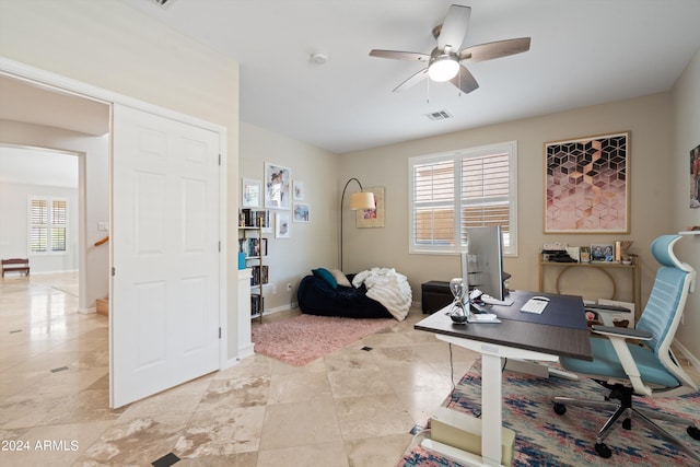 office area with a ceiling fan, visible vents, plenty of natural light, and baseboards