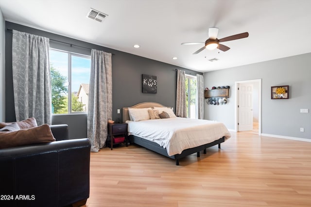 bedroom featuring ceiling fan, light wood-style flooring, recessed lighting, visible vents, and baseboards