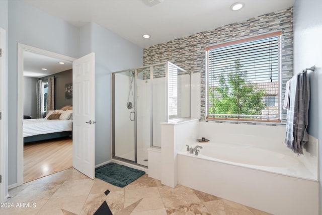 full bath with a stall shower, recessed lighting, a bath, and ensuite bathroom