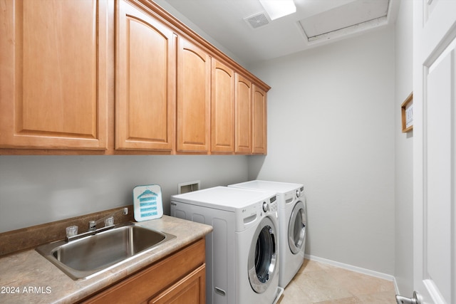 laundry area featuring a sink, visible vents, cabinet space, washer and clothes dryer, and attic access