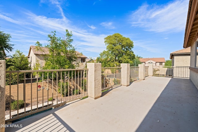 view of patio / terrace with fence and a residential view