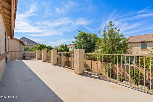 view of patio / terrace with a mountain view and fence