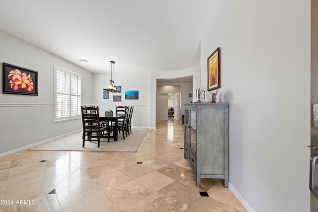 dining space with light tile patterned floors, visible vents, and baseboards