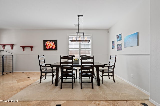 dining area with visible vents, baseboards, and a notable chandelier