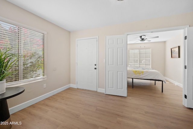 entrance foyer featuring light hardwood / wood-style floors, ceiling fan, and a healthy amount of sunlight