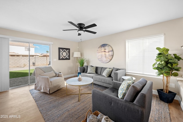 living room with ceiling fan and light hardwood / wood-style floors