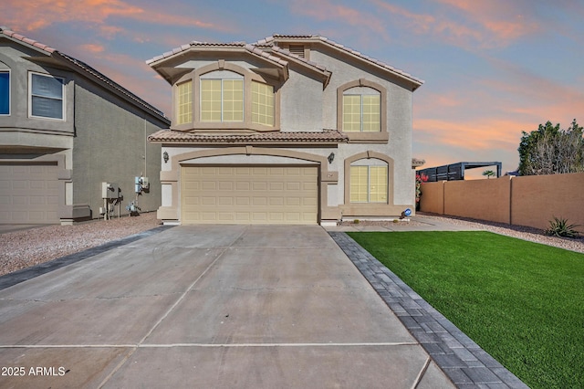 view of front of property featuring a lawn and a garage