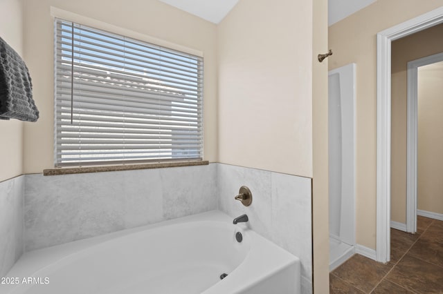 bathroom with tile patterned floors and shower with separate bathtub