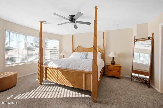 carpeted bedroom with multiple windows and ceiling fan