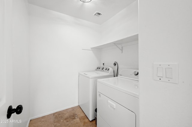 laundry room with washing machine and clothes dryer