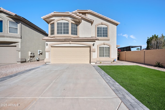 mediterranean / spanish-style house featuring a front lawn and a garage