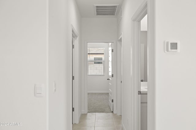 corridor with light tile patterned flooring