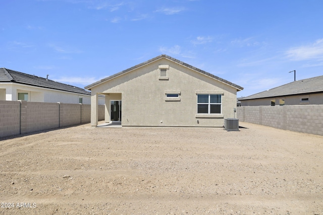 back of house featuring central AC unit