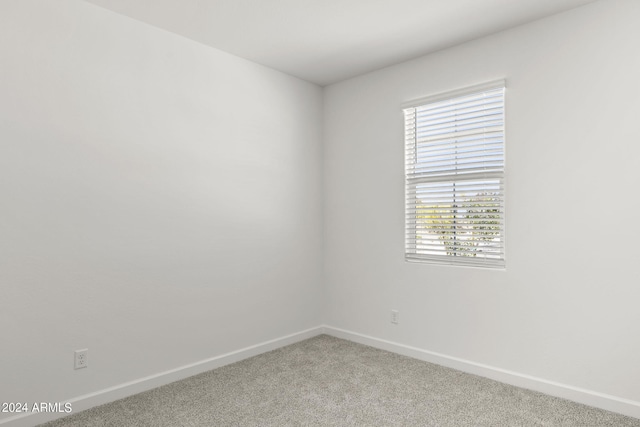 spare room featuring light colored carpet