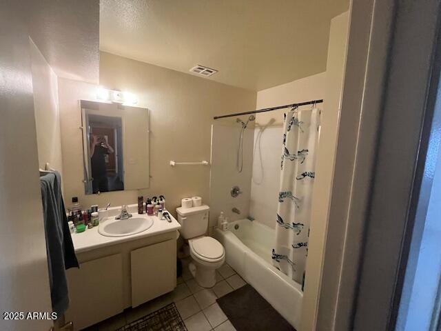 full bathroom featuring vanity, shower / bathtub combination with curtain, tile patterned floors, and toilet