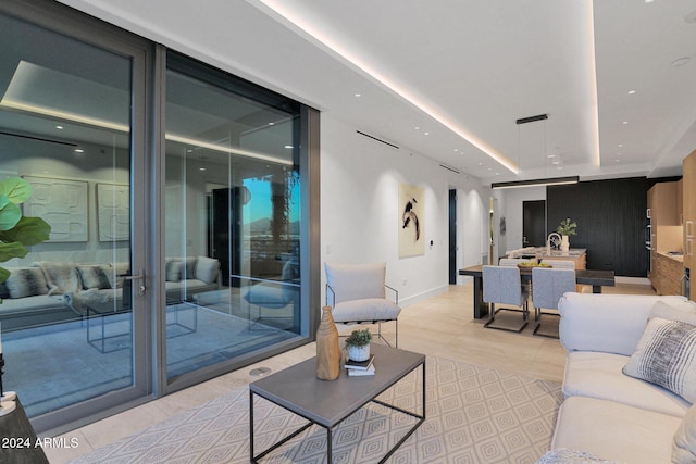 interior space with light tile patterned floors and a raised ceiling