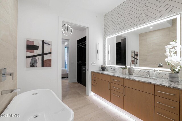 bathroom with vanity and a bath