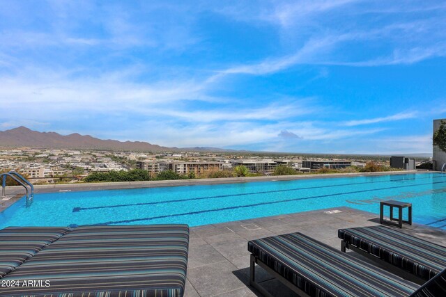 view of pool featuring a mountain view and a patio