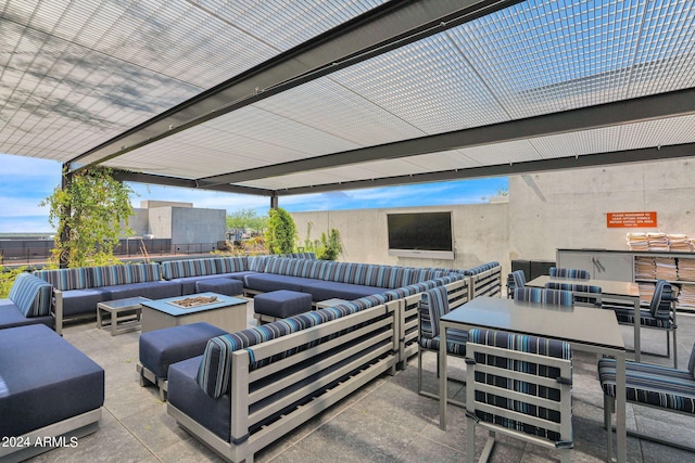 view of patio with an outdoor living space with a fire pit