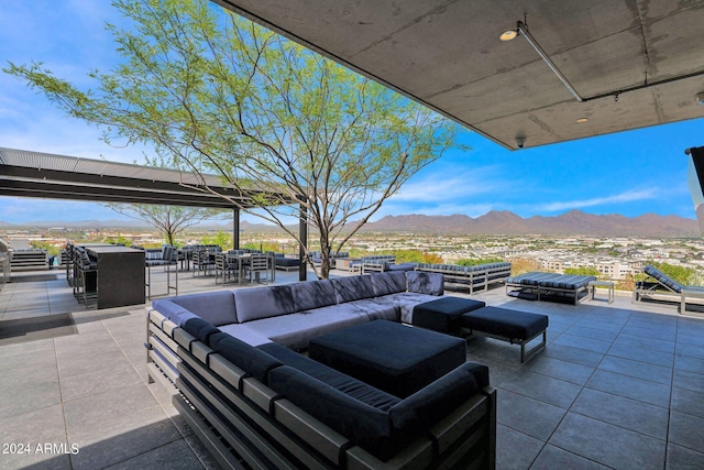 view of patio / terrace with a mountain view, area for grilling, and an outdoor hangout area