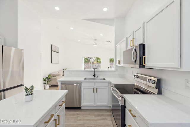 kitchen with recessed lighting, ceiling fan, appliances with stainless steel finishes, and a sink